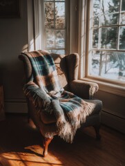 Cozy Armchair by the Window With a Warm Blanket on a Sunny Winter Afternoon