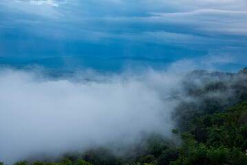 Fototapeta premium Beautiful Mountain landscape foggy windy mountain range green landscape asian farm. Amazing Landscape mountain green field meadow white cloud blue sky on sunrise. Countryside sunlight heaven scenery