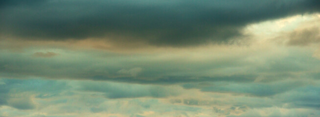 Banner Dramatic dark storm clouds black sky background. Dark thunderstorm clouds rainny season. Panorama Meteorology danger windstorm disasters climate. Dark cloudscape storm cloud with copy space.