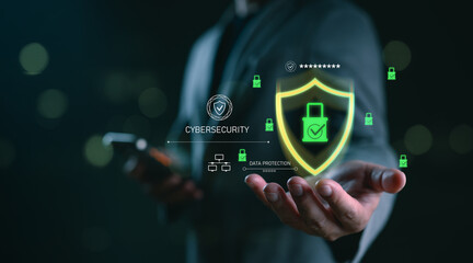 Cybersecurity and data protection concept with businessman holding glowing shield and padlock icon, representing secure network, encryption, digital safety, privacy system and online threat defense.