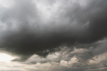 Obraz premium Dramatic dark storm thundercloud rain clouds on black sky background. Dark thunderstorm clouds rainny landscape. Meteorology danger windstorm disaster climate. Dark cloudscape storm disaster gray sky