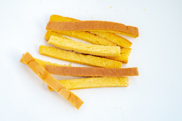 Dried crust strips from sliced white bread, collected as leftover edges. Once discarded, these golden pieces are now repurposed for crunchy snacks or toasted garnishes.