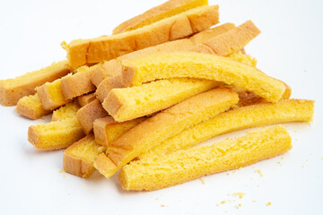 Dried crust strips from sliced white bread, collected as leftover edges. Once discarded, these golden pieces are now repurposed for crunchy snacks or toasted garnishes.