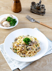 Spaghetti with Mushroom Cream Sauce in White Ceramic Plate