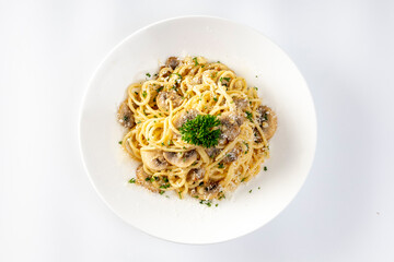 Spaghetti with Mushroom Cream Sauce in White Ceramic Plate