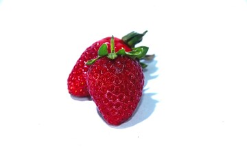 Fresh Red Strawberrys with Green Leaves on White Background