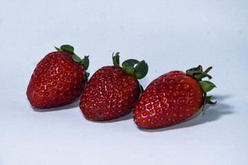 Organic Fresh Strawberries on White Backdrop.