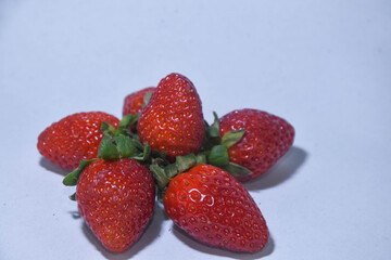  red strawberries in white background