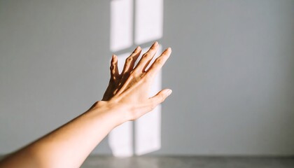 Extended hand reaching for light