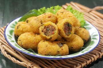 Combro is made from grated cassava which is shaped round or oval and filled with oncom and chili sauce and then fried.