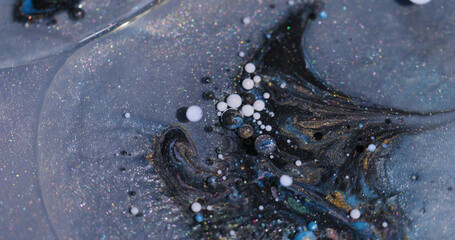 Sparkling drop. Paint oil pigment. Defocused blue black golden color shimmer fluid bubbles liquid floating on abstract background.