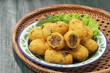 Combro is made from grated cassava which is shaped round or oval and filled with oncom and chili sauce and then fried.