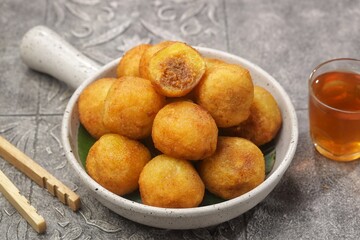 Misro or Klenyem is a snack made from grated cassava, the inside of which is filled with brown sugar and then fried