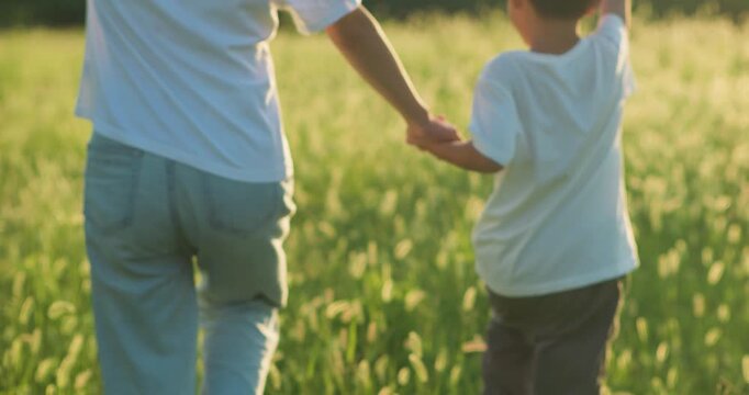 Chinese mother and son playing with foxtail grass outdoors