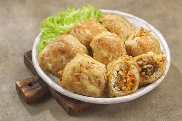 Tahu Isi. Stuffed tofu is known as fried food in the form of brown tofu filled with various fillings.