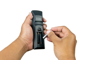 Selective focus on man hand holding tv remote control and changing battery isolated on white background. Replacement, spare parts of device. Watching television at home