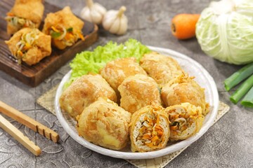 Tahu Isi. Stuffed tofu is known as fried food in the form of brown tofu filled with various fillings.