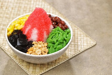 Ais kacang is a dessert that is quite popular in Malaysia and Singapore which contains cendol, red beans, chopped fried peanuts, black grass jelly and red syrup