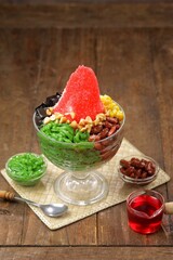 Ais kacang is a dessert that is quite popular in Malaysia and Singapore which contains cendol, red beans, chopped fried peanuts, black grass jelly and red syrup
