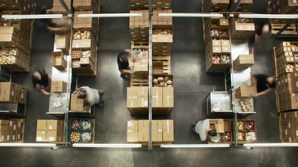 Busy warehouse workers quickly fulfilling orders, dynamic motion in supply chain facility, efficient logistics in action, overhead view, fast-paced operation - Powered by Adobe