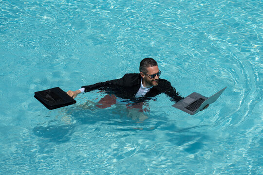 Eastern businessman taking a break. Tropical career escape. Stylish millennial enjoying success. Online work in pool. Wealthy tourist relaxing. Hot summer holiday retreat. Motivated freelancer. - Powered by Adobe