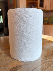 White paper towel roll on wooden table