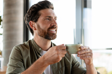 Happy manager enjoying a coffee break in the office