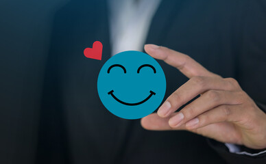 Hand holding paper cut circle symbol face smile, happy, relax, satisfaction survey, customer services, positive, good, wellness, health child, hospital, world mental health day concept