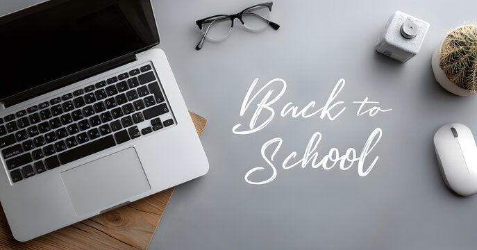 Flat lay of open laptop, spectacles, plant, with digital-style overlay text "Back to School"