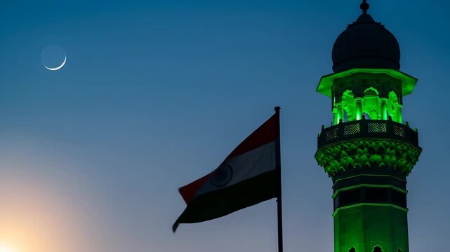 Indian eid milad un nabi celebration a beautiful mosque minaret illuminates the dusk with a flag and crescent moon
