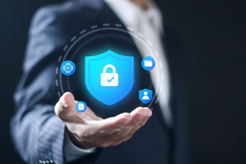 Data protection and privacy concept, Data security technology. Businessman showing cybersecurity shield icon on virtual screen.