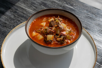 A bowl of solyanka soup in a cafe. 