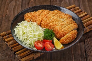 Crispy chicken katsu is a Japanese dish consisting of pieces of chicken (usually breast fillet) coated in breadcrumbs (panko) and fried