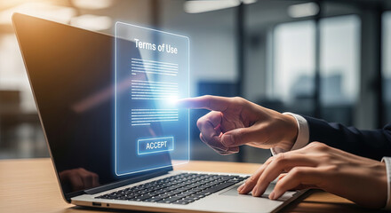 Businessperson accepts the terms of use by clicking the virtual accept button on the laptop