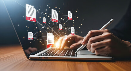 Hand manipulates floating PDF icons with a stylus on a laptop, digital document sharing