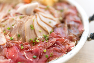 A set of raw various ingredients for mookata served on pan