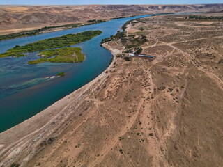The Ili River and the sandy coastal area. The largest river in Semirechye. The view from the drone. Summer time of the year.