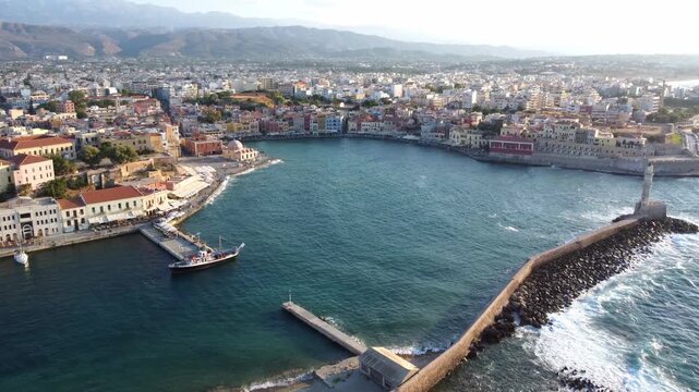 Drone shot of city of Chania along the coast of island Crete, Venetian port of Chania, Establishing shot