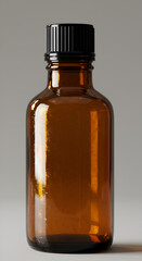 Photo of a Brown Glass Bottle With Black Lid on a Gray Background