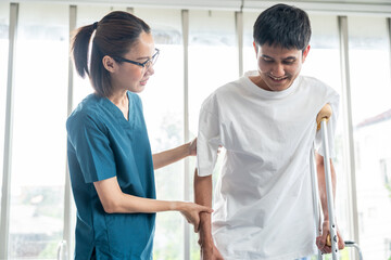 Obraz premium Physical therapy. Female Nurse aids young man in recovering from spine injury and providing orthopedic massage Orthopedic healthcare and chiropractor with person for physical therapy rehabilitation