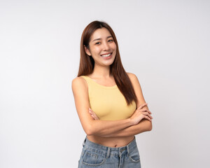 Beautiful smiling happy young asian woman in yellow shirt. Charming female lady standing pose on isolated white background. Asian woman people looking camera confident with backdrop.