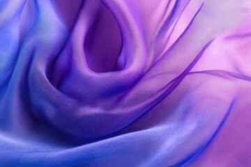 Obraz premium A close-up view of a vibrant, flowing fabric showcasing a soft ombre effect of blue and purple hues.