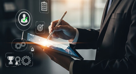 Professional uses digital pen on a tablet showing graphics and icons overlaying the screen