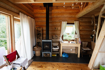 Cozy wooden cabin interior with a fireplace and rustic furniture setup