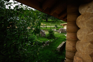 Fototapeta premium A scenic backyard view surrounded by green vegetation and wooden architecture