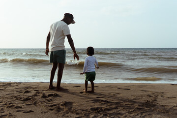 Father and son sharing a special moment on the beach, enjoying vacation together