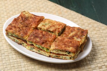 Martabak telor. Martabak is a dish commonly found in Saudi Arabia, Yemen, India, Bangladesh, Indonesia, Malaysia, Singapore, Southern Thailand and Brunei