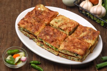 Martabak telor. Martabak is a dish commonly found in Saudi Arabia, Yemen, India, Bangladesh, Indonesia, Malaysia, Singapore, Southern Thailand and Brunei