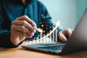 Business growth and technology success person analyzing financial data with laptop and digital graph overlay