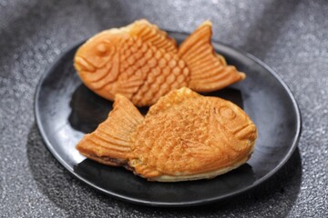 Bungeoppang Taiyaki is a popular Japanese fish-shaped cake filled with red bean jam, usually sold as a street food.